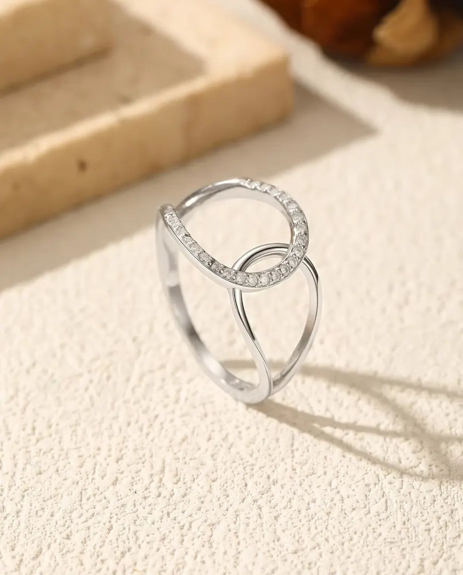 Interlocking Circle Ring in 925 Sterling Silver - standing upright on a cream textured surface