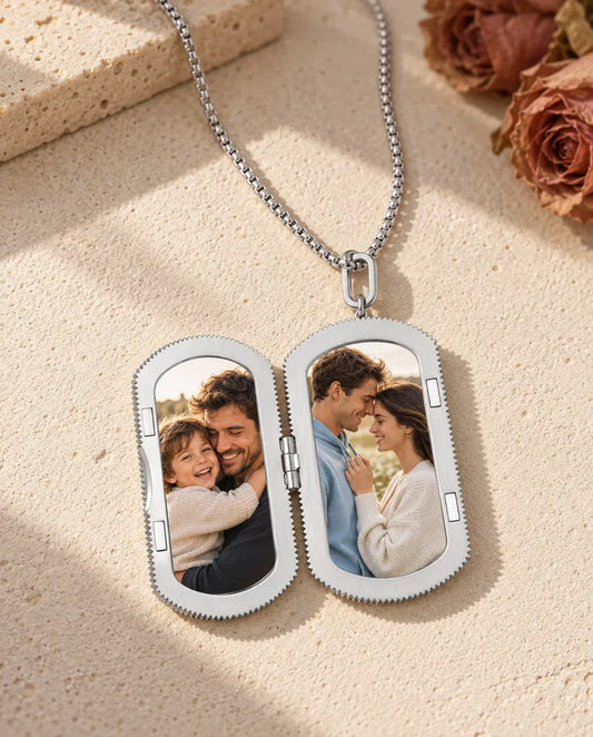 Silver dog tag photo locket necklace open, showing two photos inside