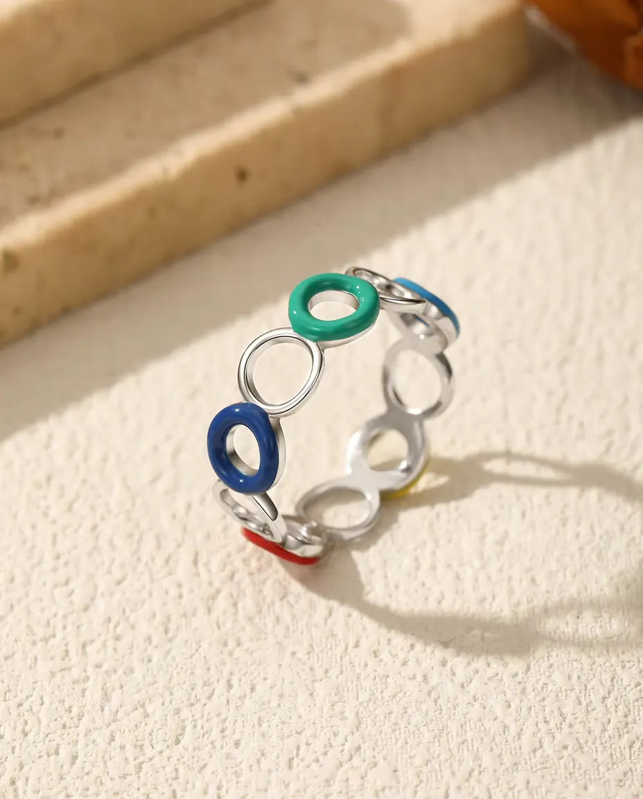 Enamel Circle Ring in 925 Sterling Silver - standing upright on a cream textured surface
