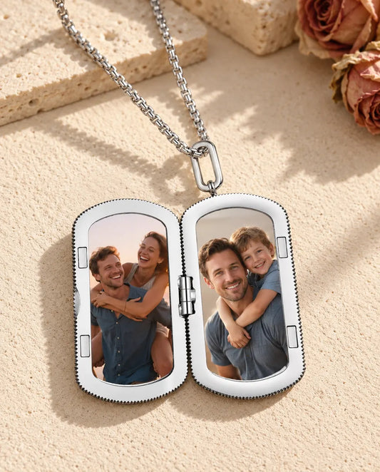 Silver dog tag photo locket necklace open, showing two photos inside