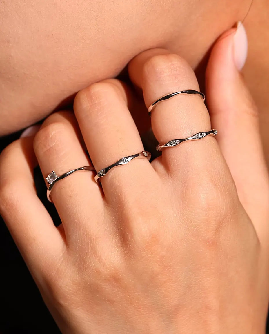 Moissanite Wave Ring in 925 Sterling Silver - worn with other rings, close-up of the fingers