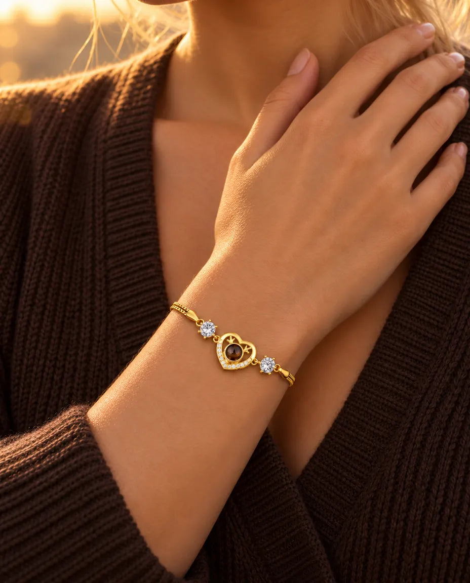 Close-up of the gold tone antler heart bracelet with cubic zirconia on a wrist resting at the collarbone