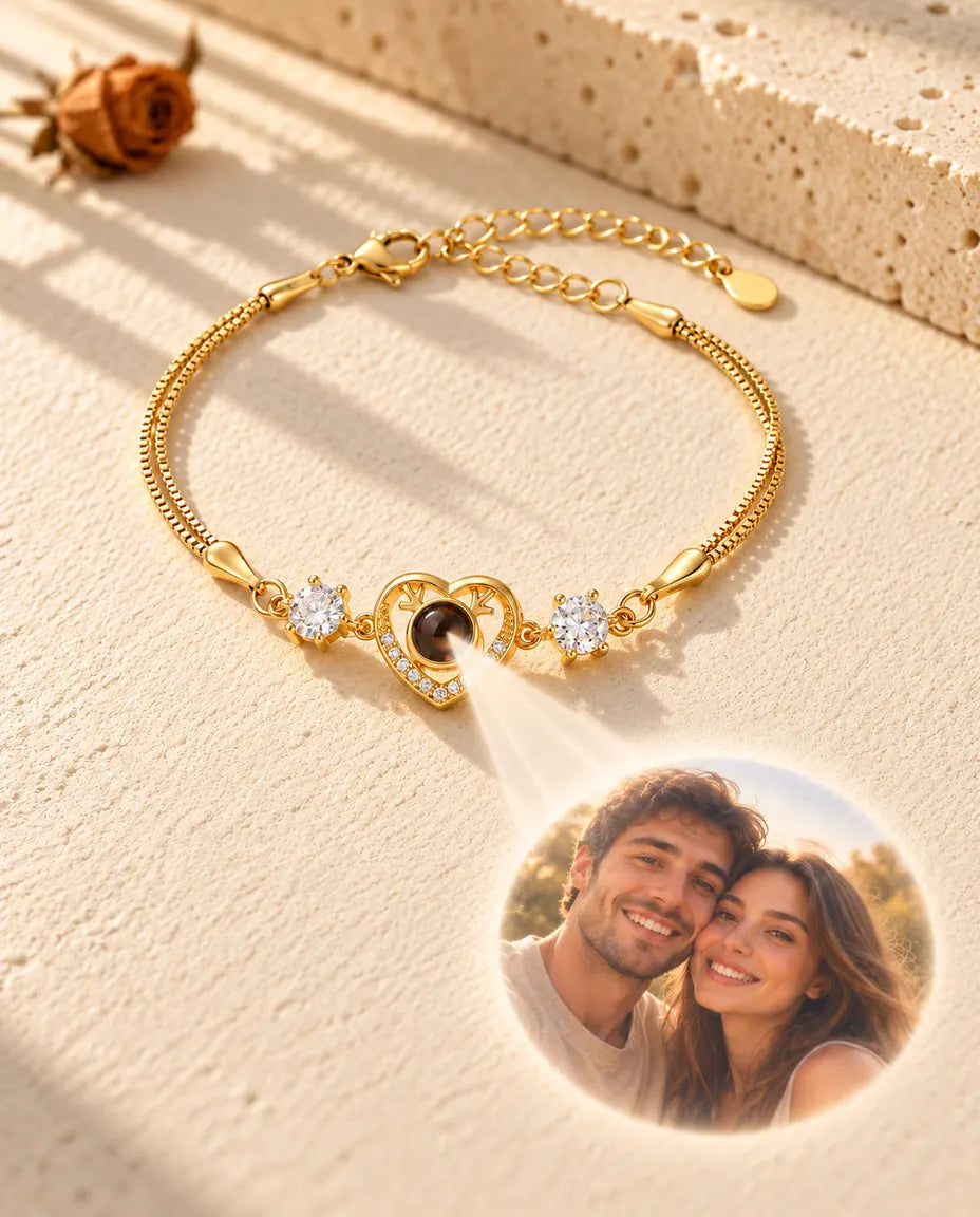 Light through the brown stone of the gold tone heart charm projects a round couple photo onto the plaster