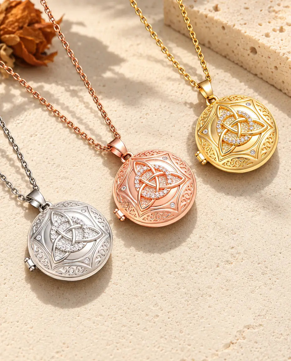 Celtic trinity knot photo lockets in silver, rose gold tone and gold tone laid diagonally on cream plaster