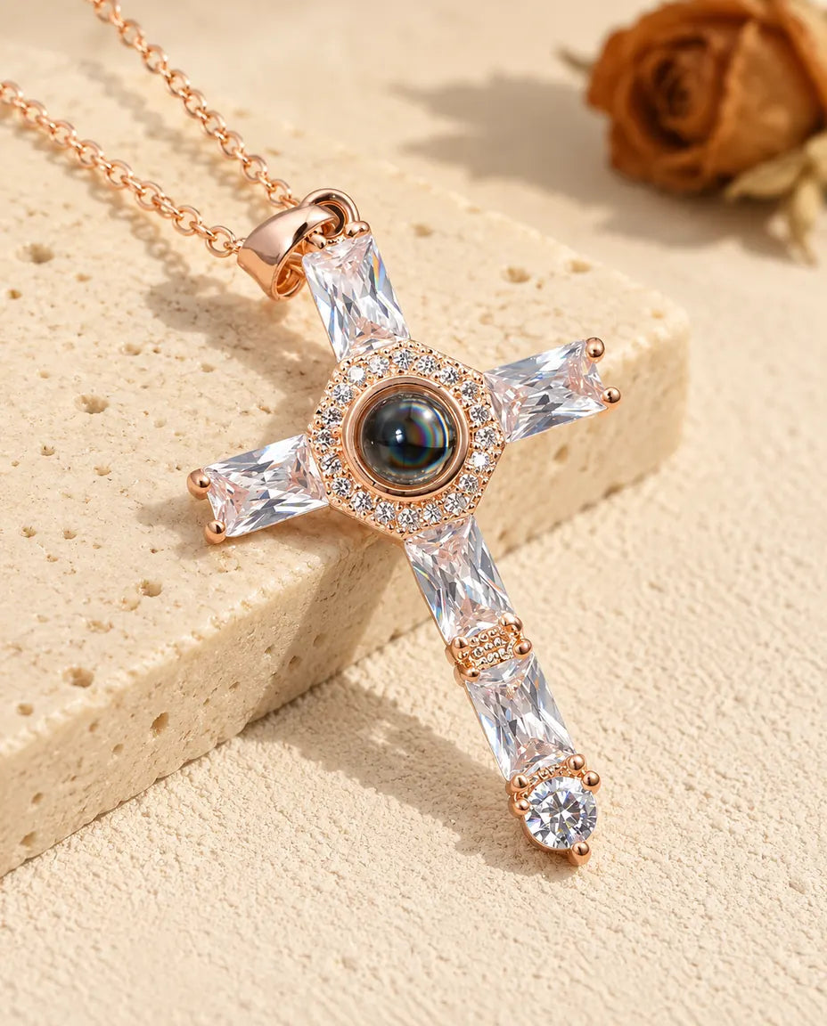 Personalised rose gold tone cubic zirconia cross photo projection necklace beside travertine