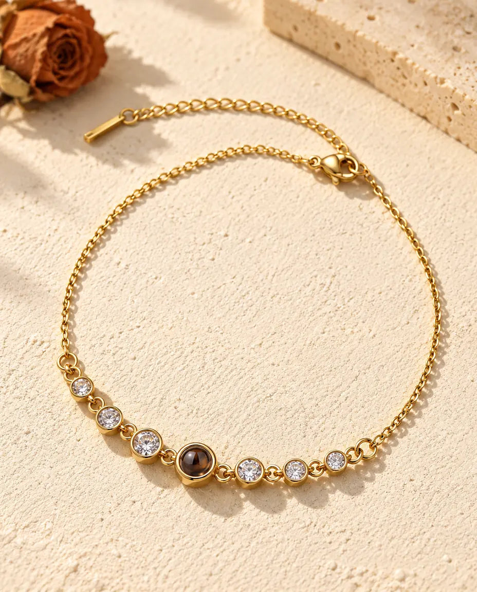 Gold tone stainless steel stone bracelet with a small brown projection stone at the centre