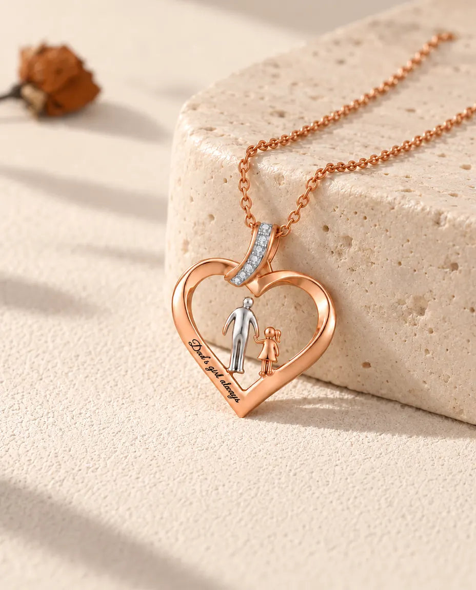Personalised dad and daughter heart necklace in rose gold tone, resting against a travertine block