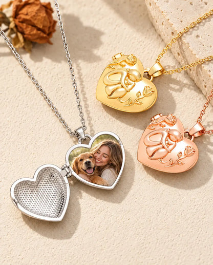 Silver tone dog lover heart locket opened to show a photo inside, beside closed gold tone and rose gold tone lockets