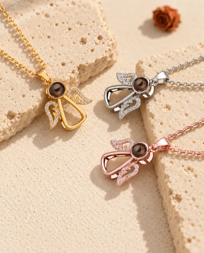 Angel photo projection necklaces in gold tone, silver tone and rose gold tone on travertine