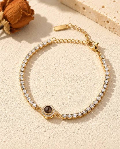 Top view of the gold tone halo tennis bracelet with its extender chain