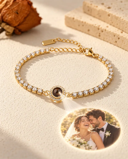 Light through the brown stone of the gold tone halo charm projects a round photo of a bride and groom