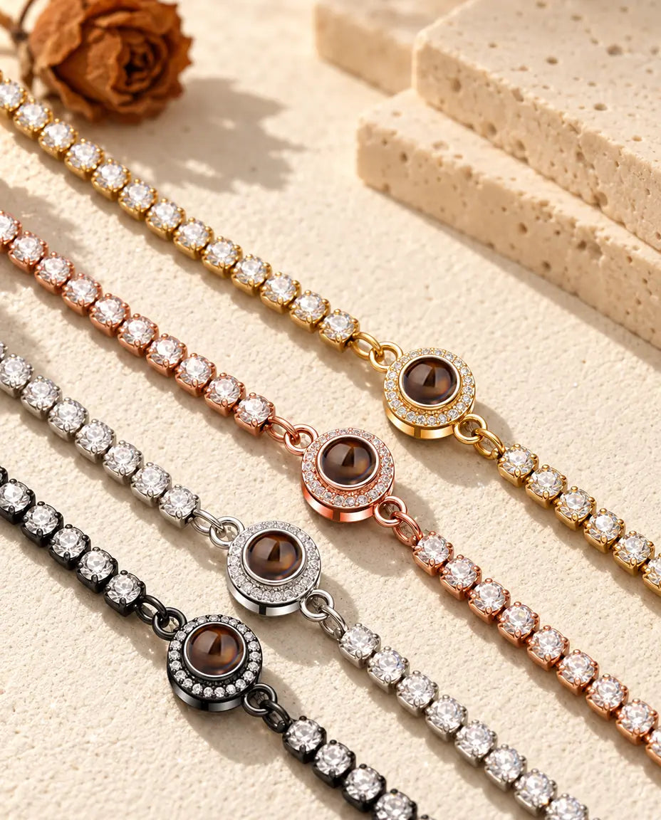 Four halo tennis bracelets in gold tone, rose gold tone, silver tone and black running side by side