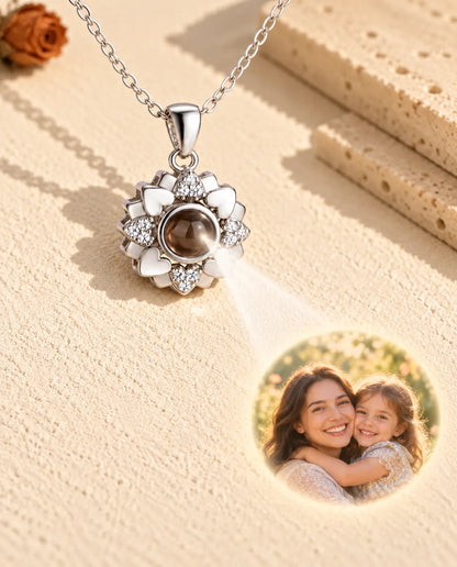 Silver tone heart flower necklace projecting a mother and daughter photo onto plaster