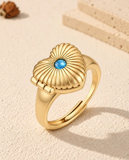 Personalised heart photo locket ring in gold tone with a blue birthstone on the fluted lid