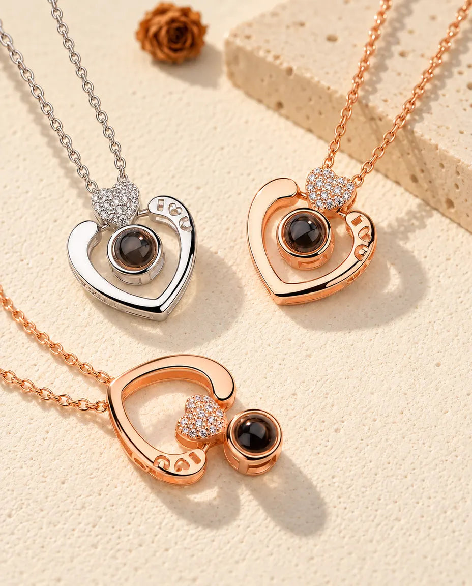 Open heart projection necklaces in silver tone and rose gold tone, one rose gold tone worn upside down