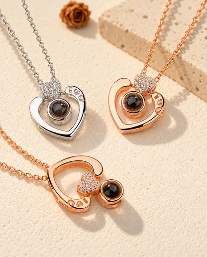 Open heart projection necklaces in silver tone and rose gold tone, one rose gold tone worn upside down