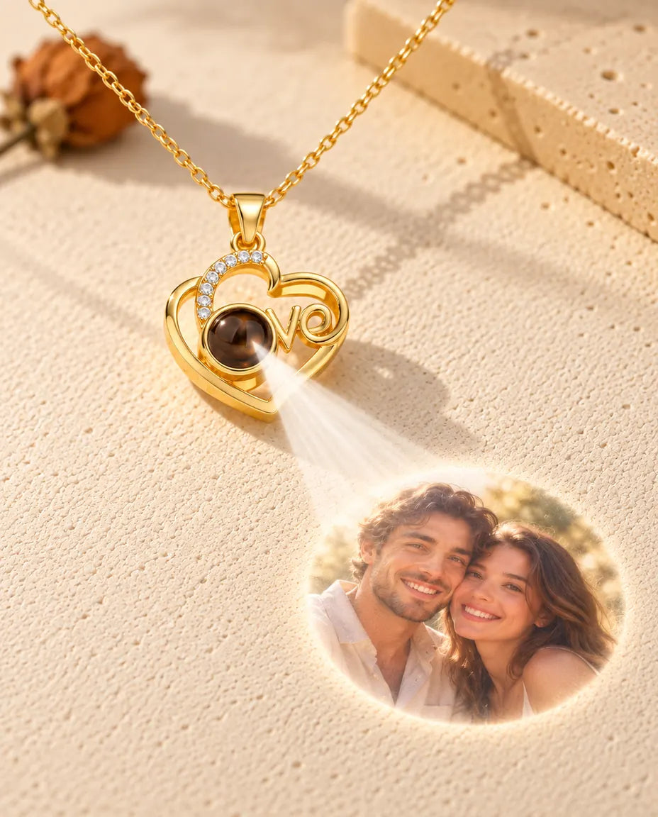 Gold tone Love heart projection necklace shining a couple photo from its stone onto cream plaster