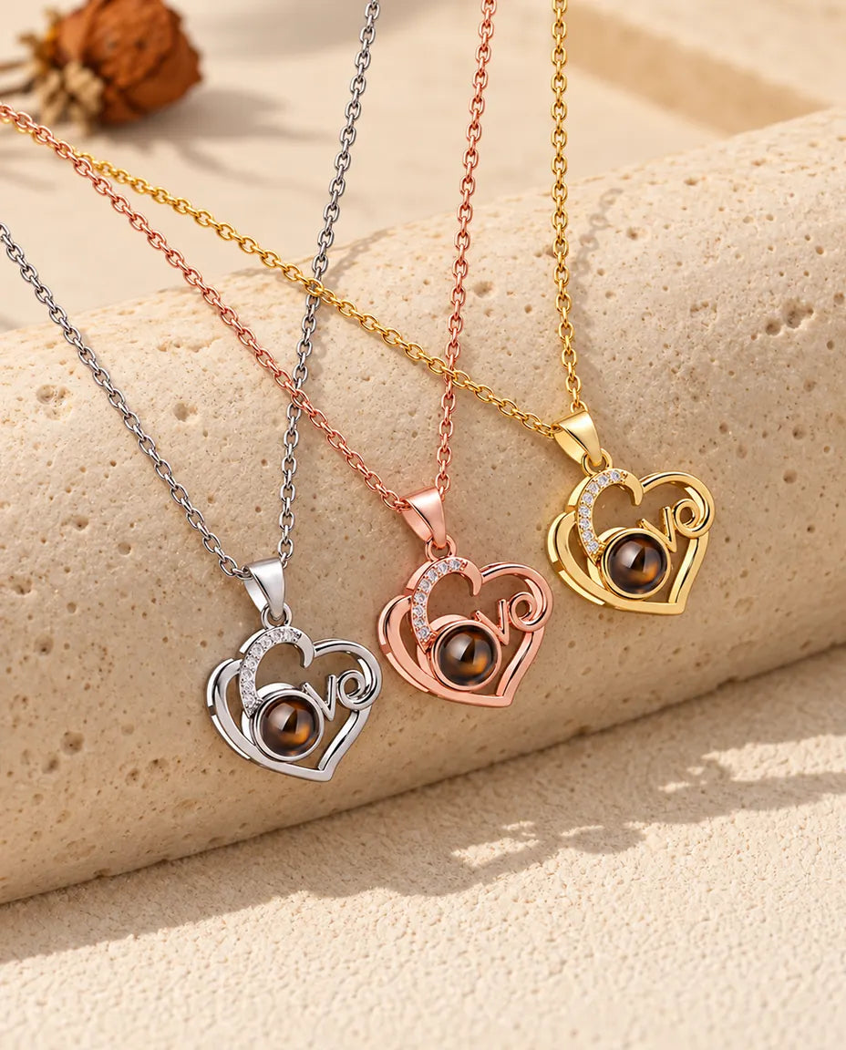 Three colours of the Love heart photo projection necklace in a row