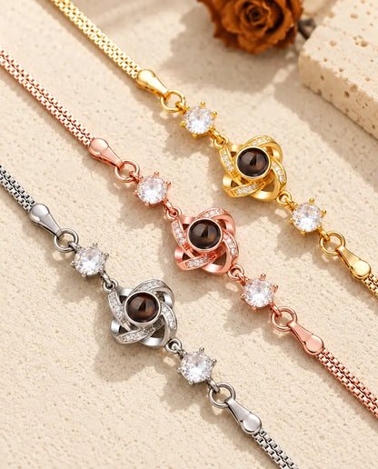 Close-up of three love knot charms with pave stones in each colour