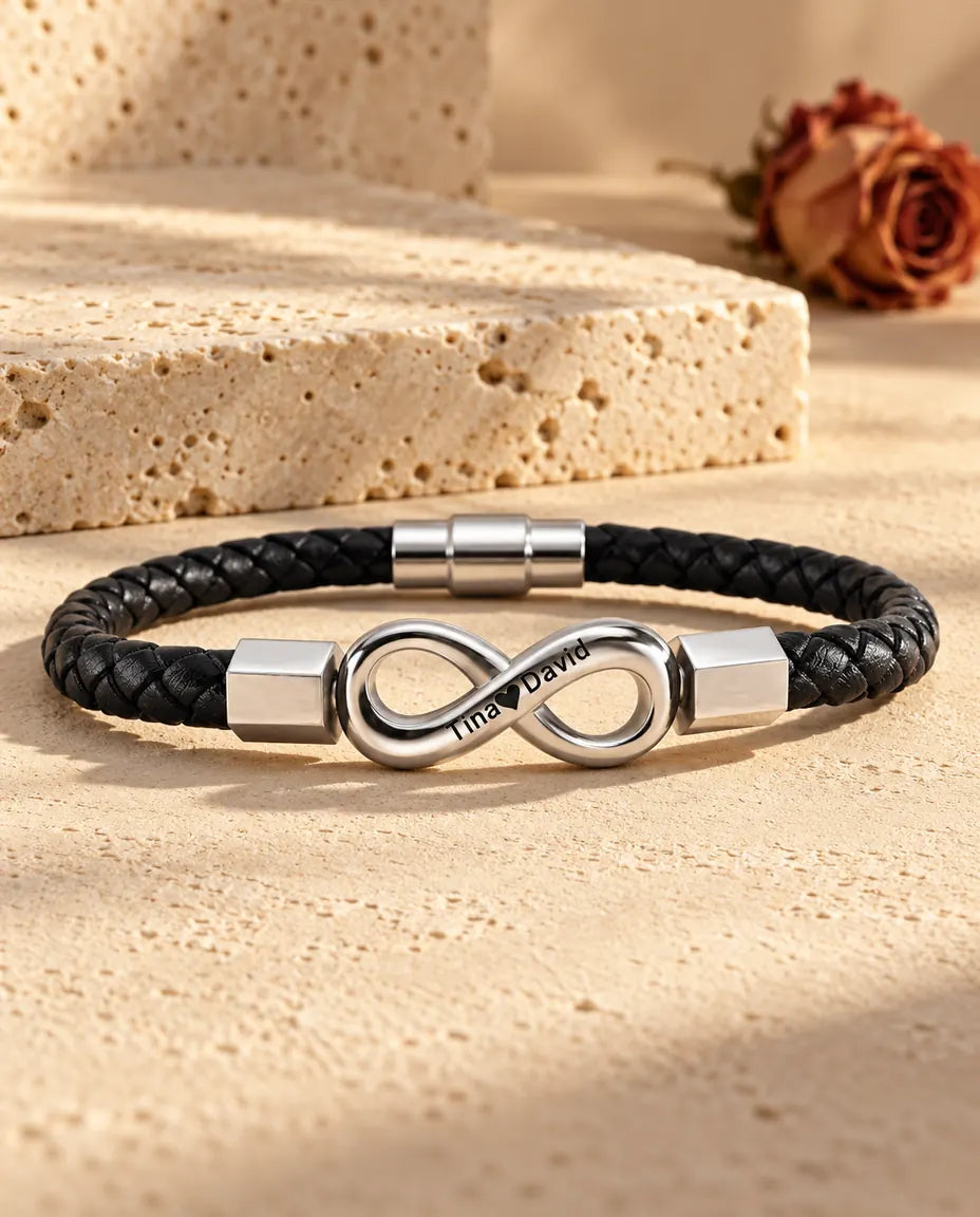 Silver stainless steel infinity link with hexagonal end caps on a black braided faux leather bracelet