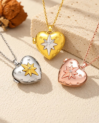 Three colours of the north star heart photo locket necklace arranged on plaster