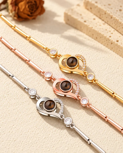 Close-up of three open heart charms with pave stones in each colour