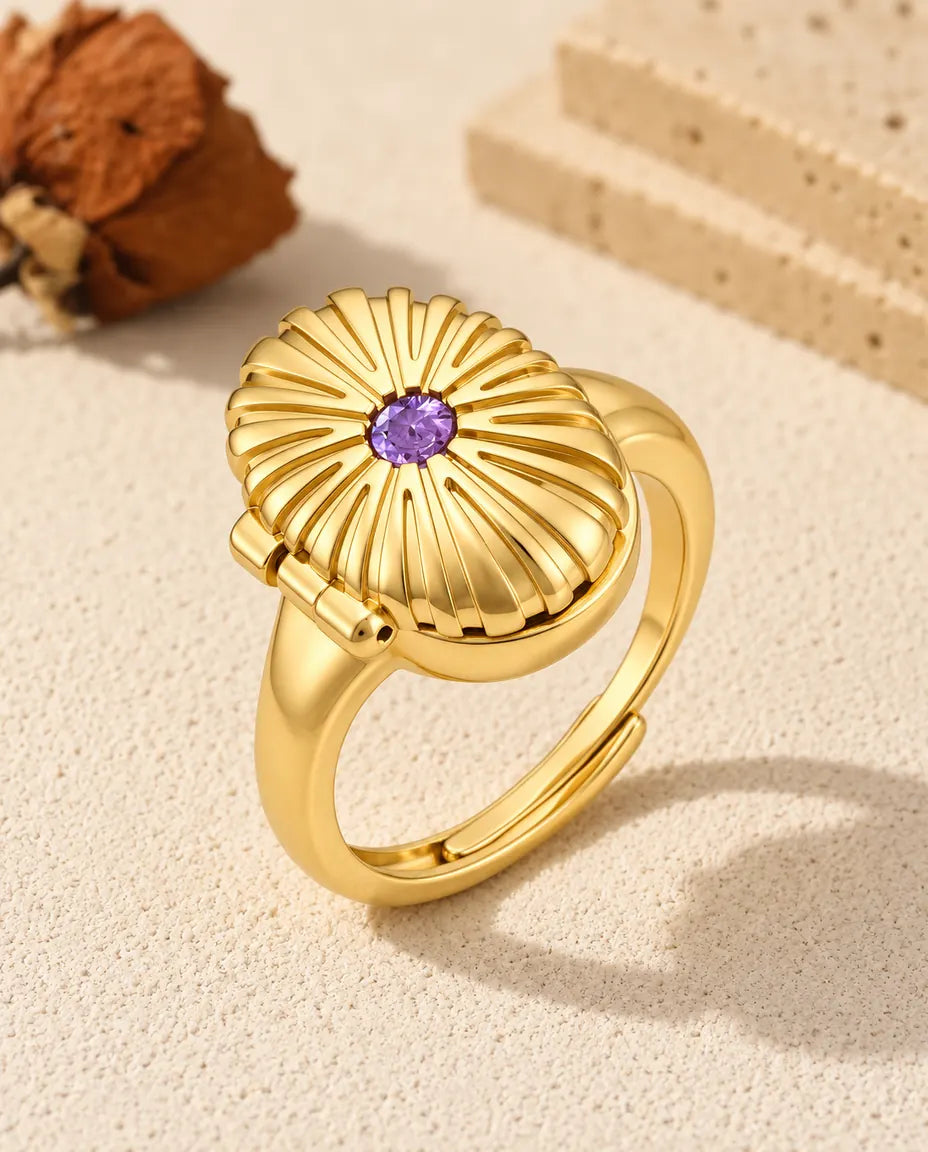 Personalised oval photo locket ring in gold tone with a purple birthstone on the fluted lid
