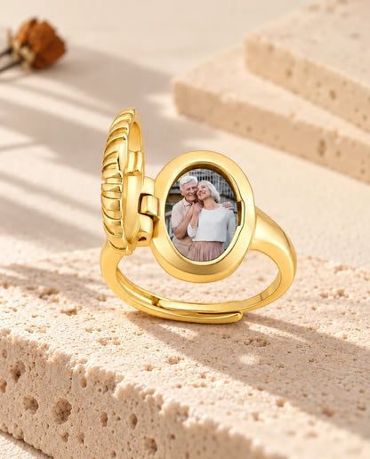 Open oval photo locket ring from the side, showing the hinge and the photo