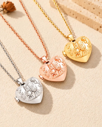 Sisters heart photo lockets in silver tone, rose gold tone and gold tone laid diagonally on cream plaster