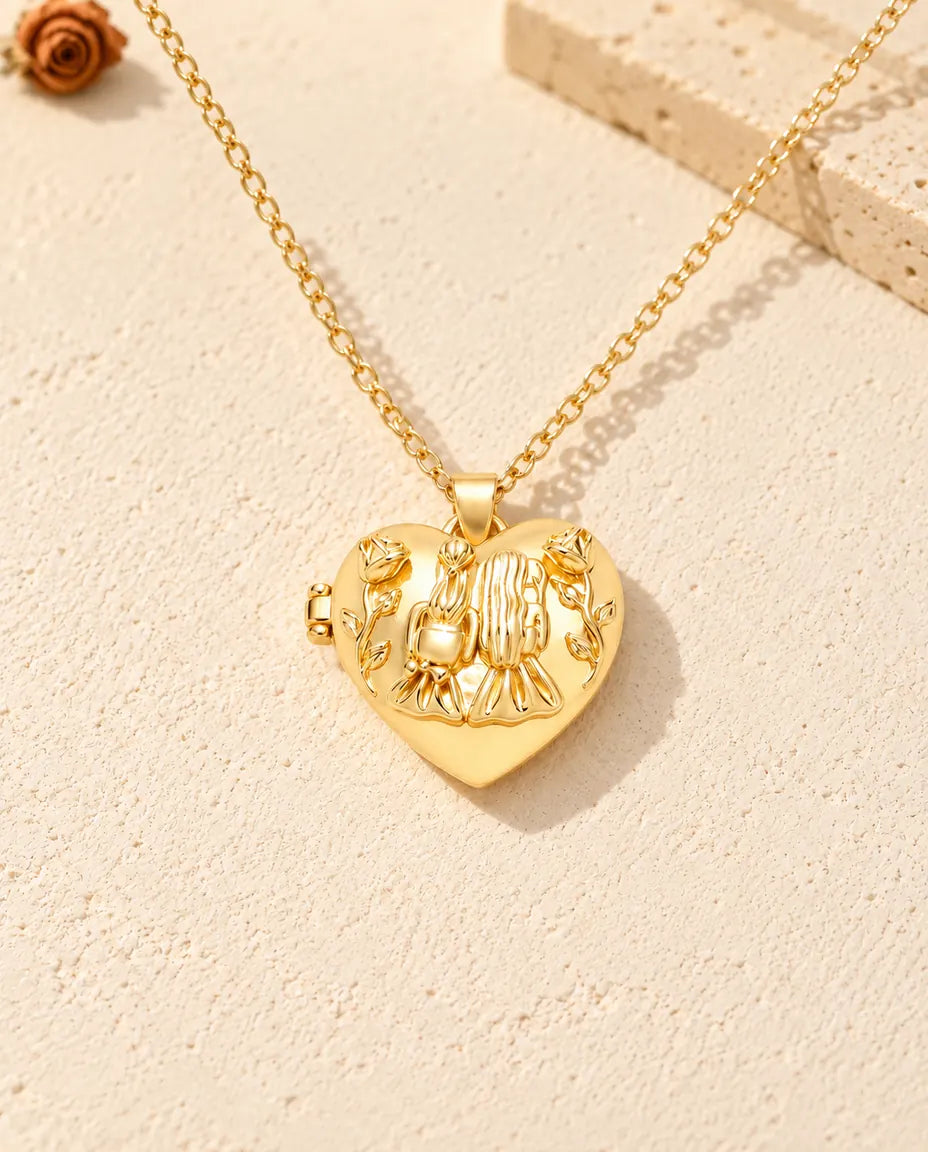 Front view of the gold tone sisters heart locket showing the lid design and side hinge
