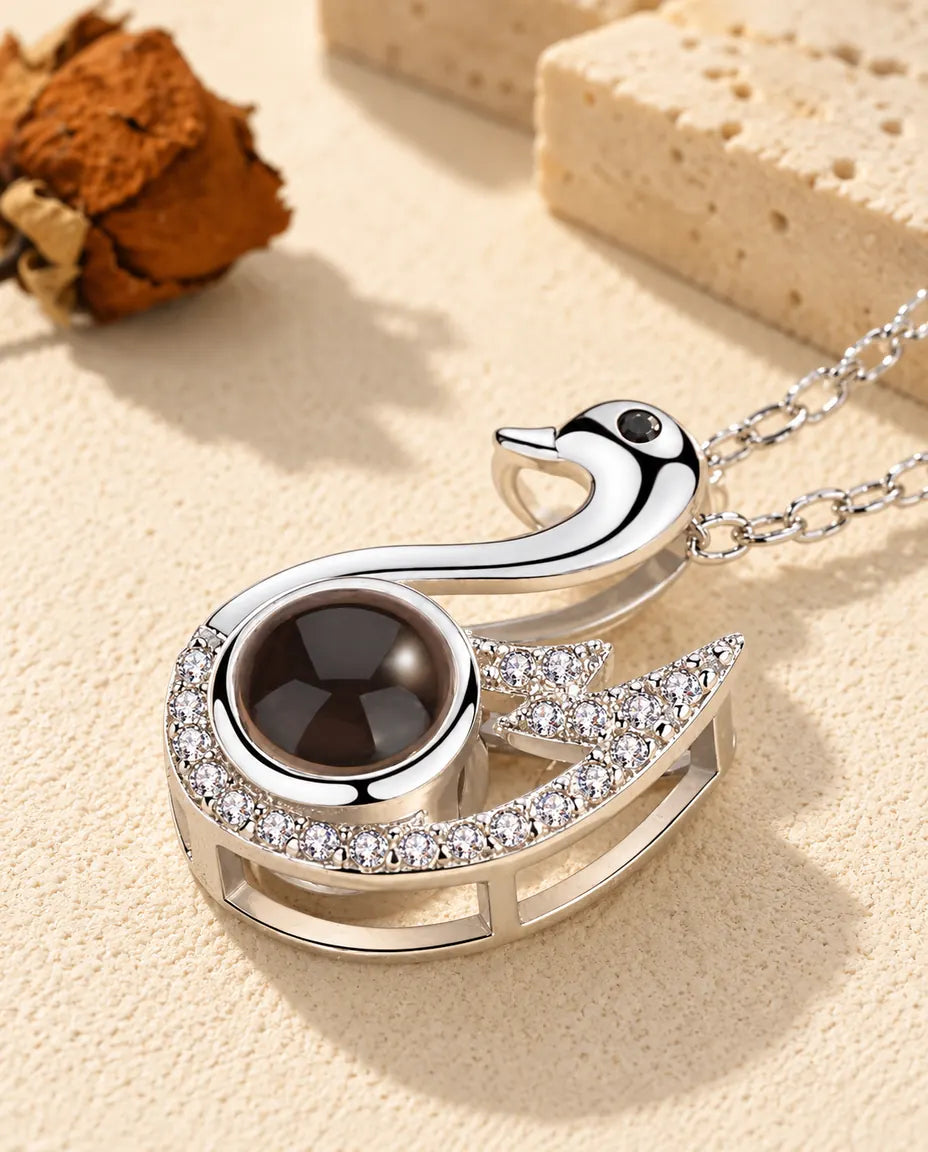 Close-up of the silver tone swan pendant with a cubic zirconia wing
