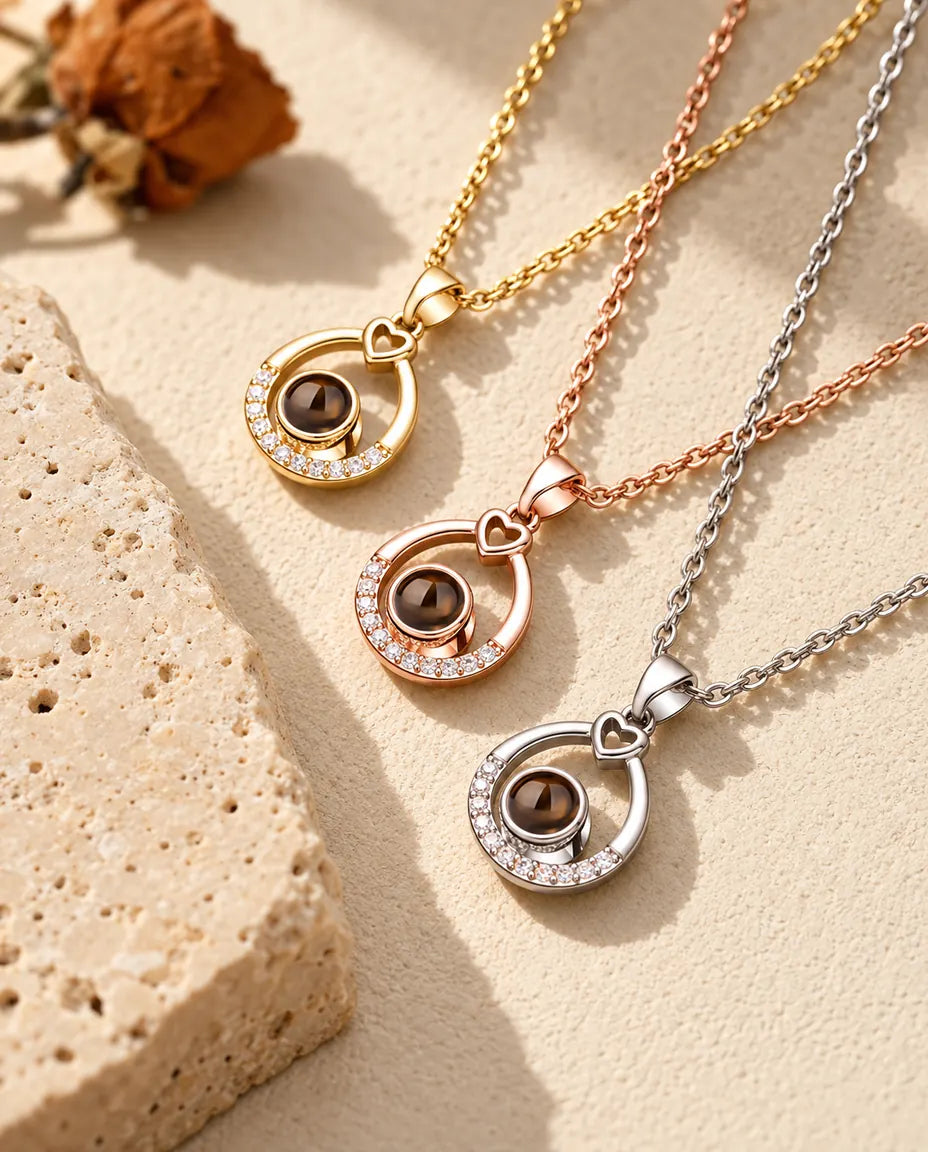 Three teardrop necklaces stacked diagonally with cubic zirconia arcs