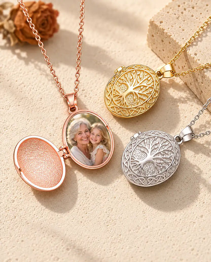 Rose gold tone tree of life locket opened to show a grandmother and granddaughter photo inside, beside closed gold tone and silver tone lockets