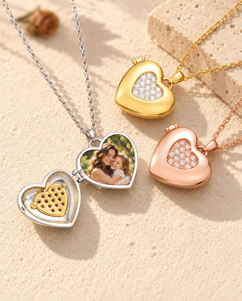 Silver tone two-tone pave heart photo locket opened to show a mother and daughter photo inside, beside closed gold tone and rose gold tone lockets