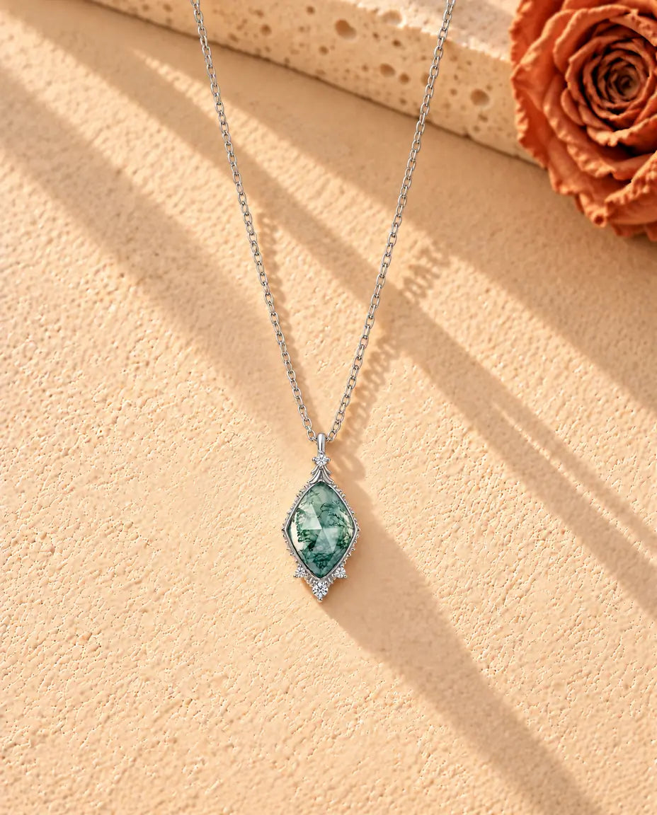 Rose Cut Moss Agate Lozenge Necklace in 925 Sterling Silver - the whole necklace laid out in a long V on a cream textured surface