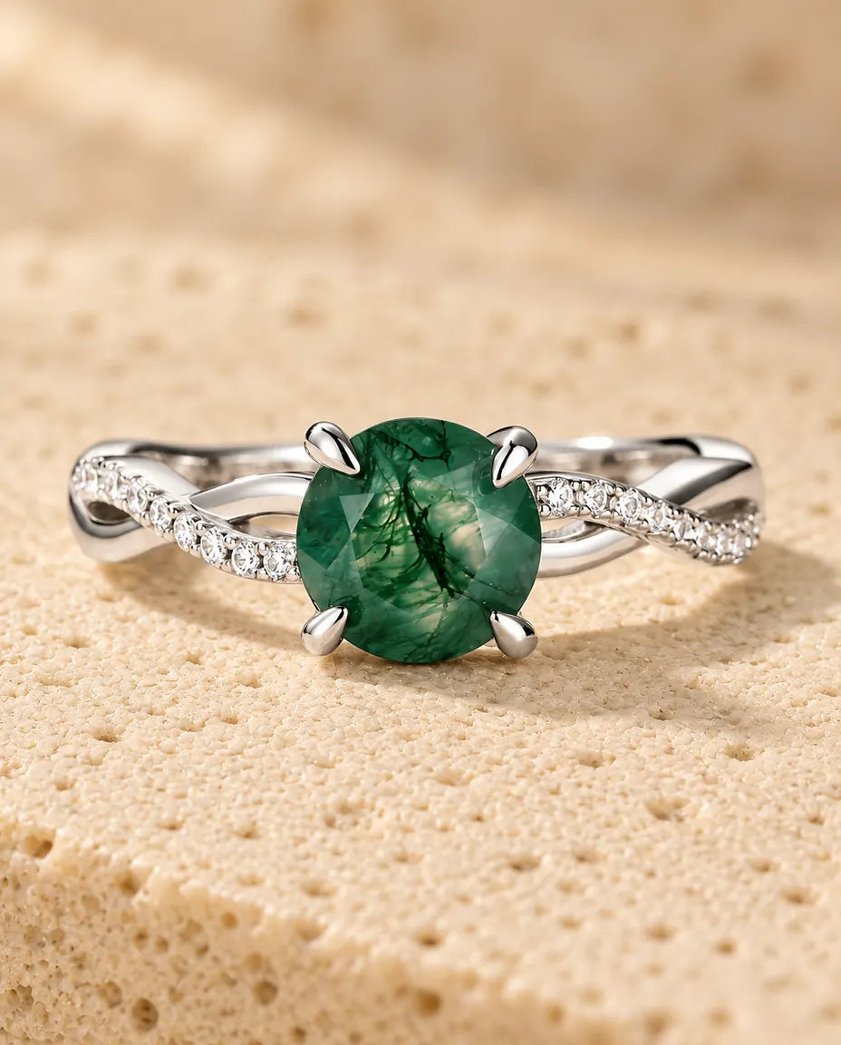 Round Moss Agate Engagement Ring in 925 Sterling Silver - lying flat on a cream textured surface