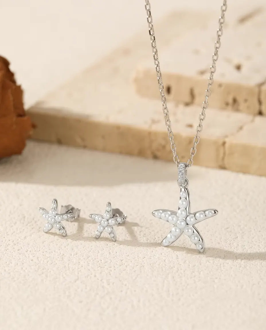 Starfish Jewellery Set in 925 Sterling Silver - the full set on a cream stone surface