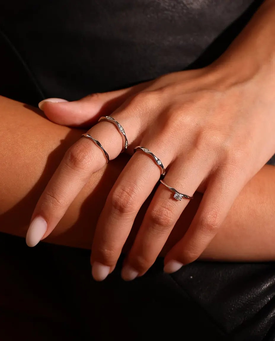 Wavy Band Ring in 925 Sterling Silver - worn together with other rings, close-up of the fingers
