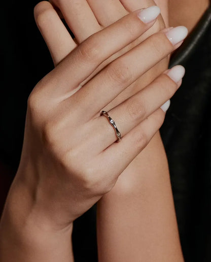 Wavy Moissanite Band Ring in 925 Sterling Silver - worn on a model’s hand